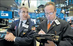  ?? RICHARD DREW/AP ?? Market watchers saw the S&amp;P 500 index drop 17.37 points to 2,632.56 Friday.