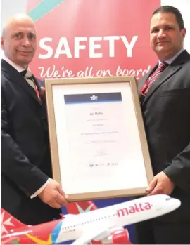  ??  ?? Air Malta’s Chief Executive Officer, Louis Giordimain­a, being presented with the IATA Operationa­l Safety Audit (IOSA) registrati­on by Captain Robin J. Zammit, Air Malta’s Head of Safety & Compliance