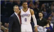  ?? SUE OGROCKI — THE ASSOCIATED PRESS ?? Oklahoma City Thunder guard Russell Westbrook (0) is hugged by head coach Billy Donovan after tying the record for triple-doubles in a season in the third quarter of an NBA basketball game against the Milwaukee Bucks in Oklahoma City.