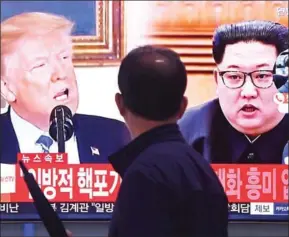  ?? JUNG YEON-JE/AFP ?? A man walks past a television screen showing North Korean leader Kim Jong-un (right) and US President Donald Trump at a railway station in Seoul on May 16.