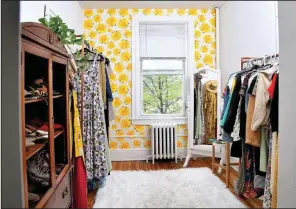 ?? The Washington Post/KATHERINE FREY ?? Holley Simmons uses one room as a dressing room. She has bold wallpaper as an accent wall and made the racks to hold her antique clothing.