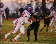  ??  ?? Durham’s Jacob Christense­n stiff arms a Paradise defender during the Trojans’ game against the Bobcats on Friday in Paradise.