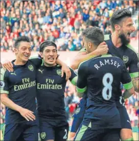  ?? AFP ?? Arsenal's Olivier Giroud (R) celebrates with teammates after scoring their fourth goal.