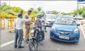  ??  ?? UP Police officials check vehicles at the Delhi-Noida border in New Delhi on Sunday. —PTI