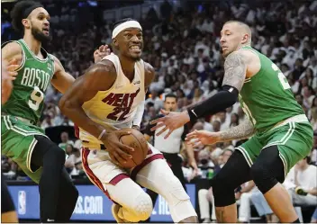  ?? LYNNE SLADKY — THE ASSOCIATED PRESS ?? Miami’s Jimmy Butler (22) drives to the basket between Boston’s Derrick White (9) and Daniel Theis.