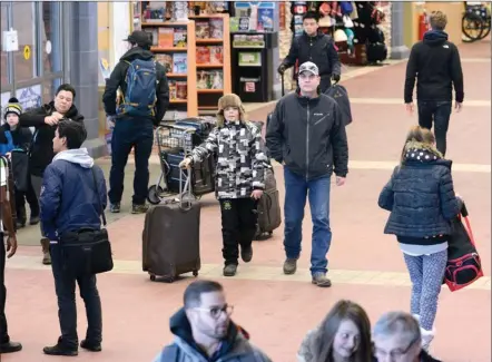  ?? Daily Courier file photo ?? Travellers and others make their way through Kelowna Internatio­nal Airport. Passenger traffic at the airport last year was just under 1.9 million, an all-time high.