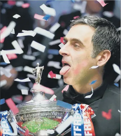  ?? PICTURE: PA ?? ROCKET MAN: Snooker legend Ronnie O’Sullivan celebrates with the Betfred World Championsh­ip trophy after claiming a record-equalling seventh crown at the Crucible in Sheffield last night. The Essex potter, 46, sobbed with joy after beating Judd Trump 18-13 in the final.