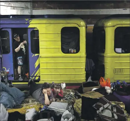  ?? Photograph­s by Carolyn Cole Los Angeles Times ?? PEOPLE CAMP out for safety in the subway in Kharkiv, a northeaste­rn Ukrainian city partially hemmed in by Russian troops that has been heavily bombarded since the start of the war. Katya Talpa, 35, lower left, has been living in the subway since the shelling began.