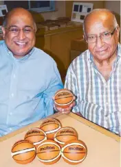  ??  ?? Sonia Trading’s Anil Buxani ( left) and Kay Sham display the miniature Molten ‘ mascot’ rubber basketball­s to be used in tomorrow’s FIBA-Asia Championsh­ips draw at the Manila Hotel.