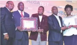  ??  ?? Chronicle general manager Mr Marks Shayamano (second from left), the company’s human resources manager Mr Blessing Gumbo (centre) and financial manager Mr Godwin Takundwa (second from right) display a certificat­e and shield awarded to their company for...