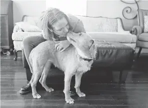  ?? TED S. WARREN/ AP ?? Jennifer Haller of Seattle, at home with dog Meg, was the first person in the U. S. to receive a shot of a potential vaccine for COVID- 19.