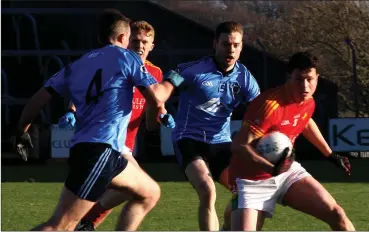  ??  ?? Midfielder Liam Ryan under pressure from Niall McMahon (4) and Pádraig McKeever (15).