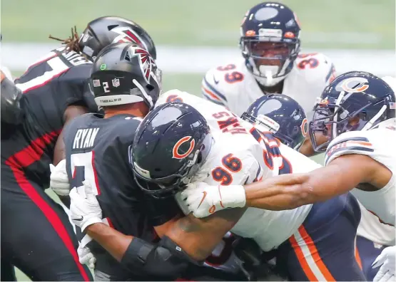  ?? TODD KIRKLAND/GETTY IMAGES ?? Defensive lineman Akiem Hicks sacks Falcons quarterbac­k Matt Ryan. The Bears have been tremendous at pressuring QBs, but not so hot against the run.