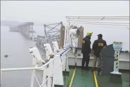  ?? Peter Knudson / NTSB photo via AP ?? NTSB investigat­ors on the cargo vessel Dali, which struck and collapsed the Francis Scott Key Bridge, on Wednesday in Baltimore.