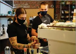  ?? PHOTOS BY DAN REIDEL — ENTERPRISE-RECORD ?? Barista Mattie Hinkley, left, steams milk as cafe manager Cooper Kosolofsky makes espresso Wednesday at Stoble Coffee and Workplace in Chico.