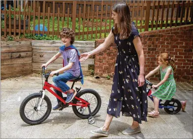  ?? PHOTOS BY PHIL SKINNER / FOR THE AJC ?? Everett Gray, 8, plays with his sister Eila and mother Kelley at their Atlanta home. Everett received a heart transplant at 3 and was diagnosed in 2018 with Stage 3 diffuse large B-cell lymphoma, which is now in remission.