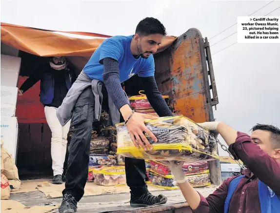  ??  ?? &gt; Cardiff charity worker Owess Munir, 23, pictured helping out. He has been killed in a car crash