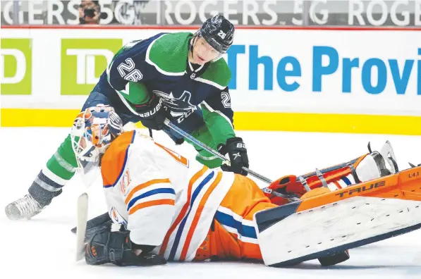  ?? — THE CANADIAN PRESS ?? Canucks left winger Antoine Roussel tries to get a shot past Edmonton goaltender Mike Smith during the second period at Rogers Arena Tuesday. While the Canucks looked as though they had the resolve, the Oilers managed to come from behind with third-period scoring.