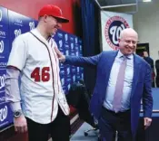  ?? AP PHOTO/PABLO MARTINEZ MONSIVAIS ?? Washington Nationals owner Mark Lerner, right, greets pitcher Patrick Corbin, left, on Friday during a news conference at Nationals Park in Washington. Corbin agreed to terms on a six-year contract.