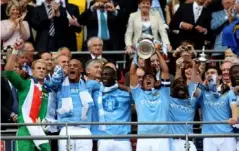  ?? (Getty) ?? Tevez captained Manchester City in the FA Cup final in 2011