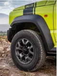  ??  ?? clockwise from top The stubby lever for the 4x4 transfer case returns; round headlamps mimic those of the SJ410 as well as the plastic flared wheelarche­s; the modern wheel design completes the rugged look.