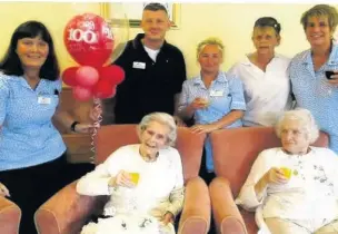  ??  ?? Margery Davis, 100, centre, receives congratula­tions at Connell Court