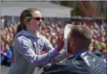  ?? ERIC BONZAR — THE MORNING JOURNAL ?? Fifth-grader Morgan Vitou, 11, presses a whipped cream pie against the face of social studies teacher Ken Murphy during Avon Heritage Elementary School’s special assembly April 30.