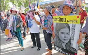  ?? HENG CHIVOAN ?? Activists hold placards in Phnom Penh yesterday as a petition is delivered to the prime minister’s cabinet.