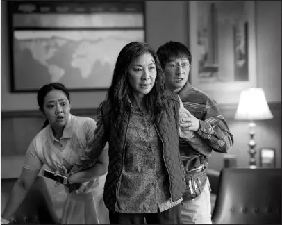  ?? ALLYSON RIGGS / A24 FILMS VIA AP ?? From left, Stephanie Hsu, Michelle Yeoh and Ke Huy Quan perform in a scene from “Everything Everywhere All at Once.”