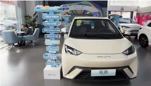  ?? AP-Yonhap ?? The Seagull electric vehicle from Chinese automaker BYD is displayed at a showroom in Beijing, April 10.