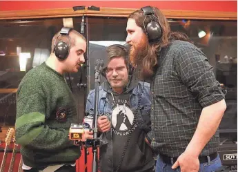  ?? JOHN KLEIN / MILWAUKEE JOURNAL SENTINEL ?? Zach Otto (from left), Harrison Colby and Conner La Mue of the band Sex Scenes record vocals during the “Unpresiden­ted” recording session at Howl Street Recordings on April 21. See more photos at jsonline.com/tap.