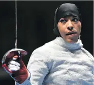  ?? FABRICE COFFRINI / AFP / GETTY IMAGES ?? Ibtihaj Muhammad became the first American to wear the hijab while competing at the Olympic Games, though it was largely hidden underneath her fencing helmet.