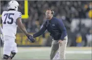  ?? MATTHEWPUT­NEY — THE ASSOCIATED PRESS ?? Penn State coach James Franklin, right, congratula­tes offensive lineman Des Holmes (Cardinal O’Hara All-Delco) during a game against Iowa last October. Both Franklin and Holmes harped on the importance of adhering to COVID-19 safety protocols this week.