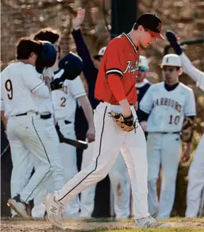  ?? WINSLOW TOWNSON FOR THE GLOBE ?? North Andover’s Dom Pefine retreats to the mound after allowing a run vs. Andover in a Merrimack Valley baseball clash.