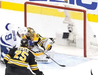  ?? GETTY IMAGES ?? The Lightning’s Tyler Johnson scores the game-winner against Bruins goalie Tuukka Rask.