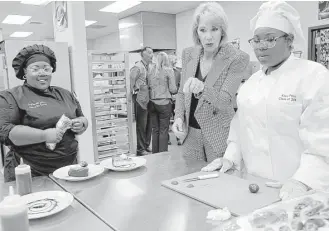  ?? Elizabeth Conley / Houston Chronicle ?? U.S. Secretary of Education Betsy DeVos visits Summer Creek High School in Humble ISD on Wednesday. She said her agency had not received a request to cancel standardiz­ed tests in Texas due to damage inflicted by Hurricane Harvey.