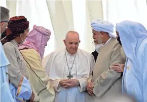  ?? GETTY IMAGES ?? Pope Francis speaks with Iraqi religious figures during an interfaith service Saturday at the House of Abraham in the ancient city of Ur.