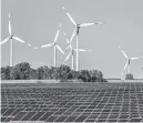  ?? MICHAEL SOHN /AP ?? Wind turbines turn behind a solar farm in Rapshagen, Germany, on Oct. 28. Climate change is going to get worse, but as gloomy as the latest scientific reports are, including Monday’s from the United Nations, scientist after scientist stress that curbing global warming is not hopeless. The science says it is not game over for planet Earth or humanity. Action can prevent some of the worst if done soon, they say.