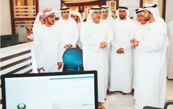  ??  ?? Abdul Rahman Al Owais interacts with officials during his visit to the candidate registrati­on ■ centre in the Abu Dhabi Chamber of Commerce and Industry yesterday.