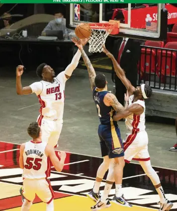  ?? DAVID SANTIAGO dsantiago@miamiheral­d.com ?? Heat center Bam Adebayo (13) blocks a shot by Pelicans guard Lonzo Ball. Adebayo had nine points on 3-of-5 shooting with three rebounds and eight assists in his first game since signing the richest contract in Heat history.