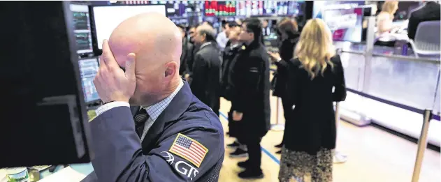  ??  ?? Unease: Traders work on the floor of the New York Stock Exchange this week at a time when uncertaint­y over trade talks is clouding the markets