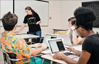  ?? BOB MCPARLAND ?? Erica Klix leads a summer workshop on computer coding in June 2019 at Richards High School in Oak Lawn. Richards is one of four Southland high schools recognized by the College Board for having at least 50% of its female students in AP computer science.