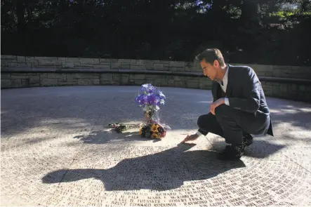  ?? Lea Suzuki / The Chronicle ?? Mark Leno touches the Circle of Friends at the AIDS Memorial Grove, where his partner Douglas Jackson’s name is etched.