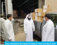  ??  ?? Boxes containing the face shields are loaded on a truck to be taken to frontline workers.