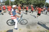  ?? STAFF ?? A man rides his bike past the Southeast Community Day Parade in 2018. The parade, held annually since 1991, except during the pandemic in 2020, was canceled last year. It likely will return.