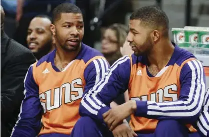  ??  ?? DENVER: In this Feb. 18, 2014, file photo, Phoenix Suns forwards Marcus Morris, left, and his twin brother, Markieff, talk on bench as the Suns played the Denver Nuggets in during an NBA basketball game in Denver. Opening statements will begin Monday,...