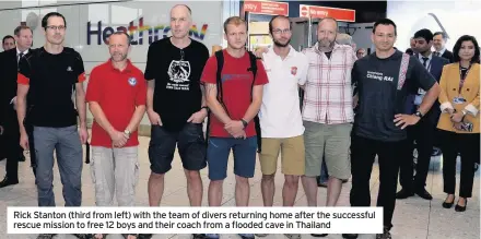  ??  ?? Rick Stanton (third from left) with the team of divers returning home after the successful rescue mission to free 12 boys and their coach from a flooded cave in Thailand