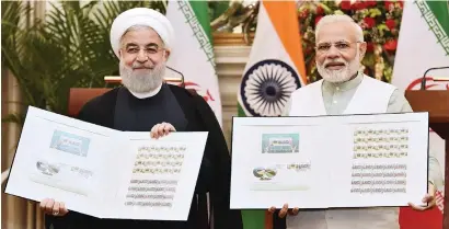  ?? AFP ?? Indian Prime Minister Narendra Modi and the Iranian President Hassan Rouhani releasing the commemorat­ive stamp celebratin­g IndiaIran relations at Hyderabad House in New Delhi on Saturday. —