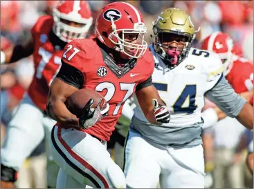  ??  ?? Georgia running back Nick Chubb (27) runs the ball against Georgia Tech in the first half of the annual rivalry game on Nov. 26