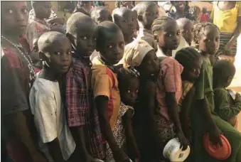  ??  ?? Displaced children, queuing for food in one of the IDP camps during the the crisis